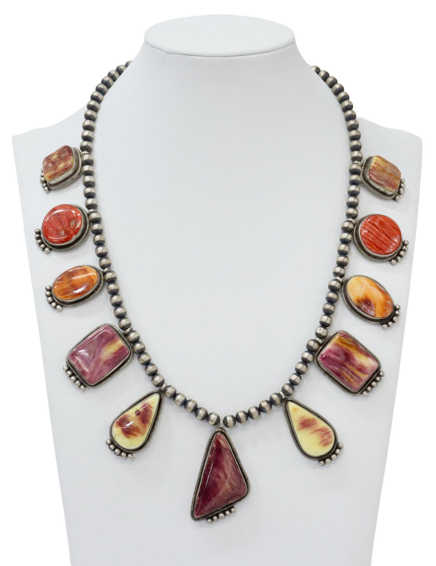 BEA TOM NAVAJO SPINY OYSTER SHELL NECKLACE: Native American sterling silver necklace, Bea Tom (Betty Tom, Navajo/ Dine, 20th c.), eleven drops set with spiny oyster shell, beaded strand, large lobster claw closure, approx 20.5"l, 120 grams (inc