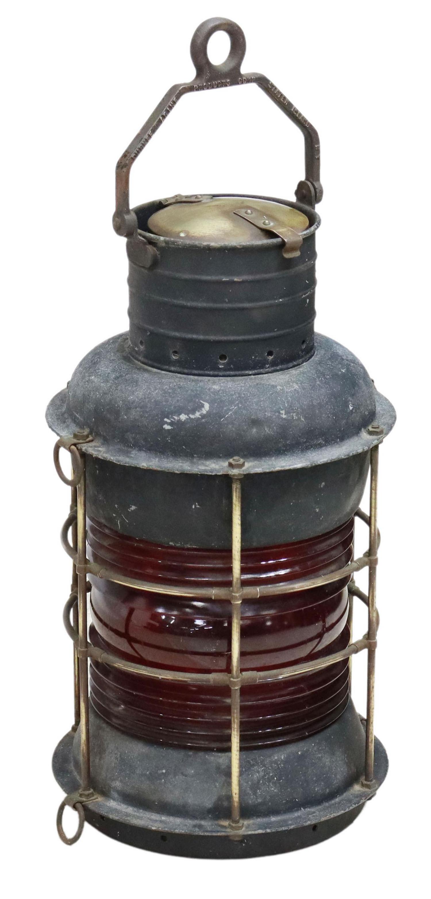 DURKEE MARINE PRODUCTS CORP. SHIP'S LANTERN: Durkee Marine brass and metal lantern, 20th c., having bail handle embossed with brand name, hinged cap, red fresnel lens, brass framework, approx 19"h, 10.5" diam, 18.5lbs Start Price: $100.00