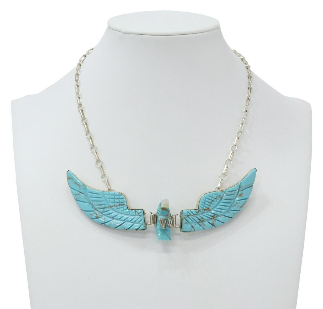 BEN LIVINGSTON CARVED TURQUOISE EAGLE NECKLACE: Native American sterling silver necklace, Ben Livingston (Navajo/ Dine, 20th c.), carved turquoise eagle, with articulated wings, on sterling link chain, hook closure, approx 15.5"l, 26.2 grams (inclu