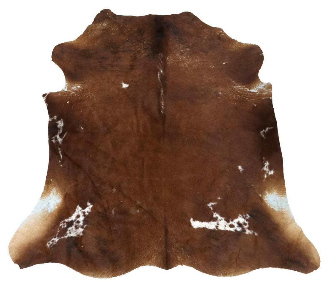 LARGE BROWN, WHITE, & BLACK COW HIDE, 79" X 77": Large cow hide, brown, black, and white, some hair loss to edges, approx 77"l, 79"w, 7lbs Start Price: $100.00