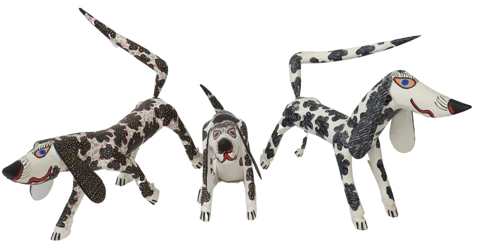(3) PORFIRIO SOSA GUTIERREZ ALEBRIJES SPOTTED DOGS: (lot of 3) Carved and painted wood alebrijes, signed at underside Porfirio Sosa Gutierrez (Oaxaca, Mexico, 20th c.), spotted dogs in standing and seated poses, largest: approx 15.75"h, 21.5"l, 5.5"w, 