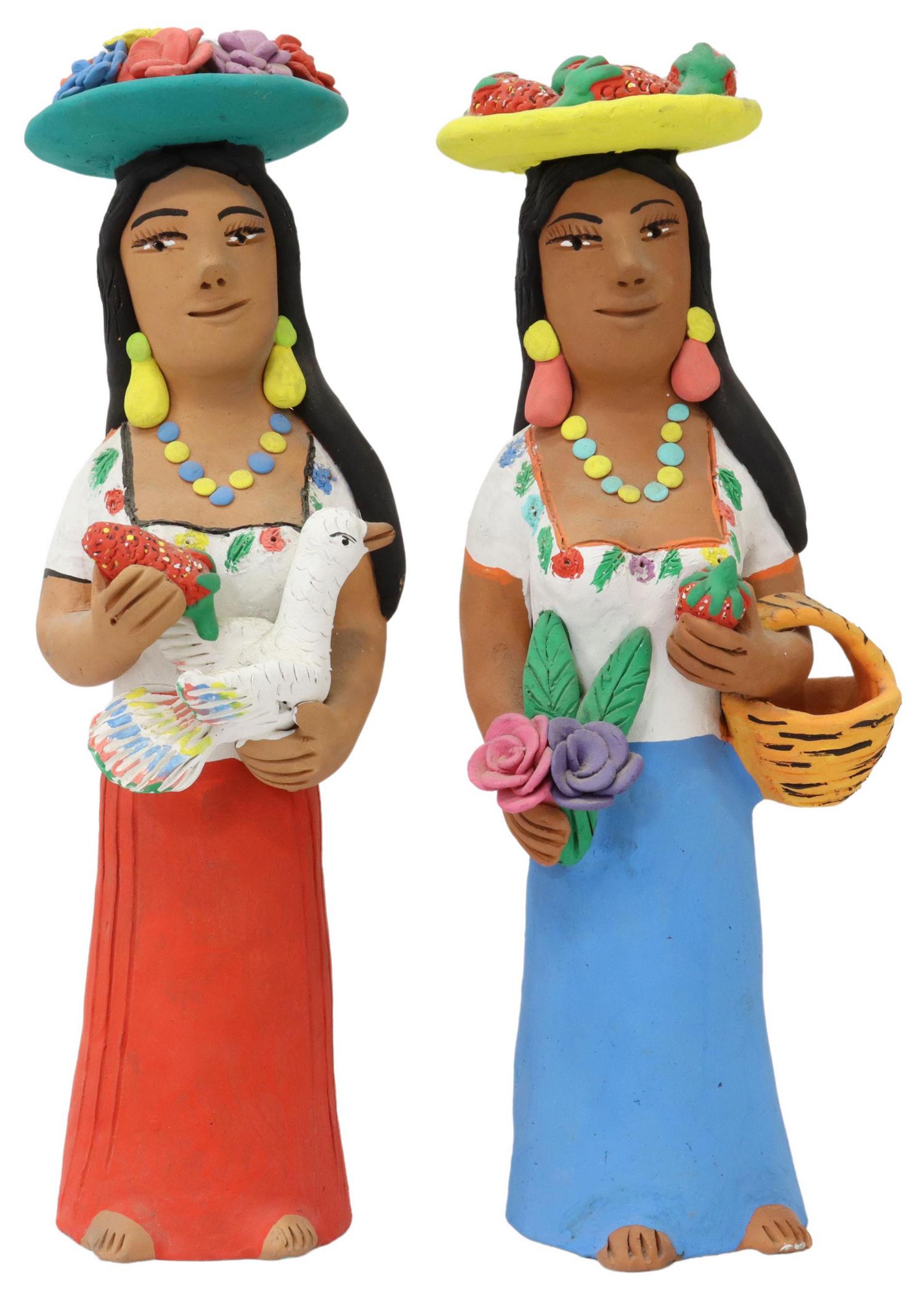 (2) JOSEFINA AGUILAR OAXACA FOLK ART MUNECAS: (lot of 2) Folk art pottery "munecas" (dolls), signed to the backs and underneath Josefina Aguilar (Oaxaca, Mexico, b.1945), each in polychrome paint, (one) holding a basket, flowers and a strawberry,