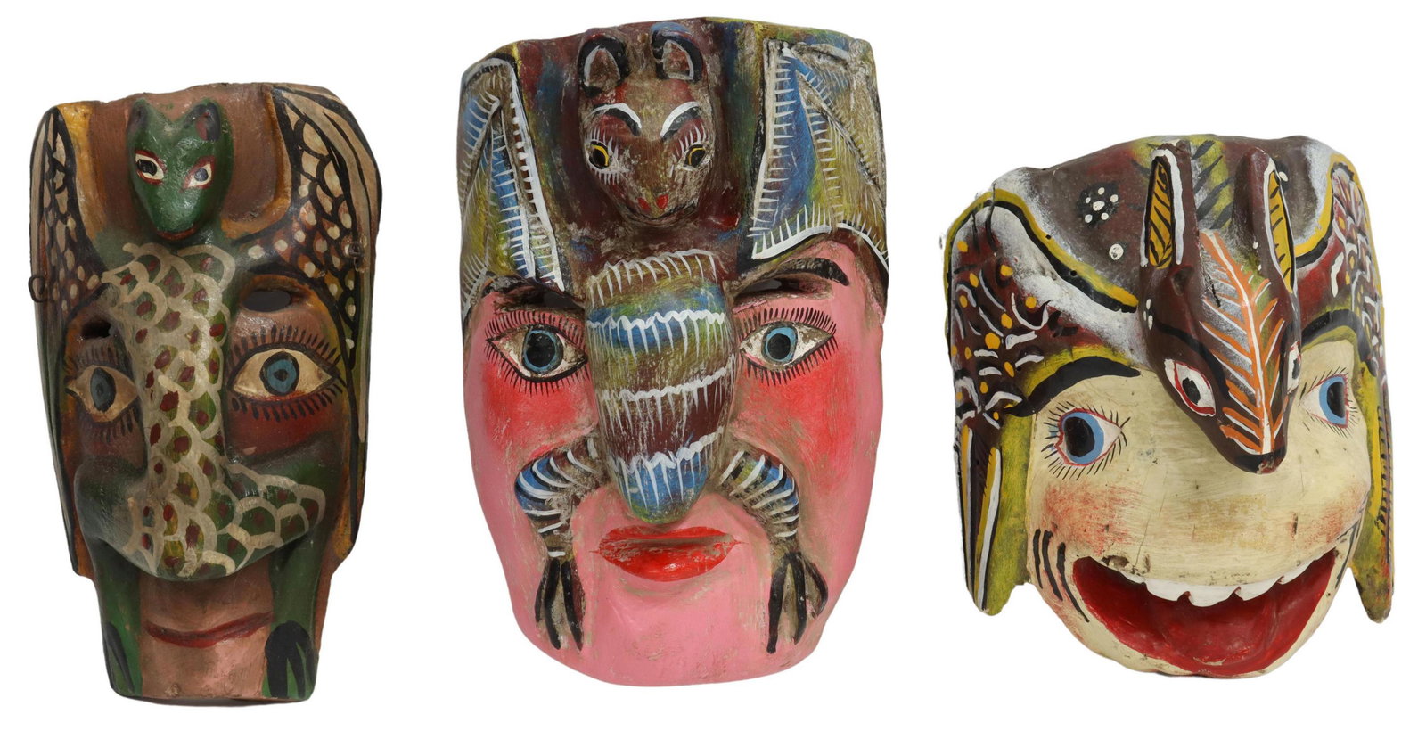 (3) MEXICO FOLK ART PAINTED FIGURAL DANCE MASKS: (lot of 3) Mexican folk art polychromed carved wood dance masks, possibly Guerrero, each face mounted with a stylized bat, (1) having pink face, (1) with open mouth (loss to wing), (1) face of tapered