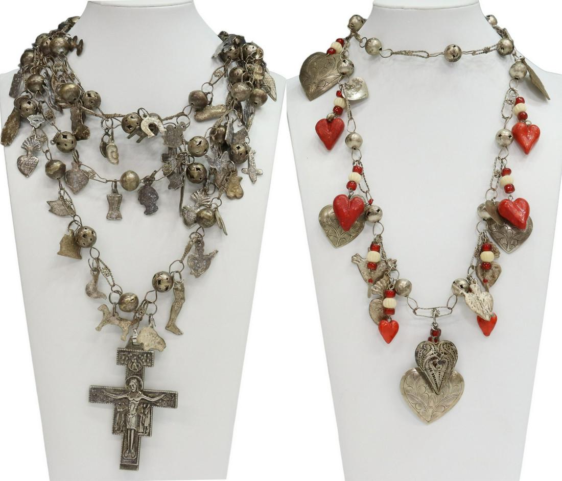 (2) MEXICO FOLK ART MILAGRO CHARM NECKLACES: (lot of 2) Folk art Milagro necklaces, Mexico, silver tone metal beads hung with numerous charms: (1) possibly a wedding necklace, ending in a large cross, "Assisi" and Latin (numbers 6:24-26) on the