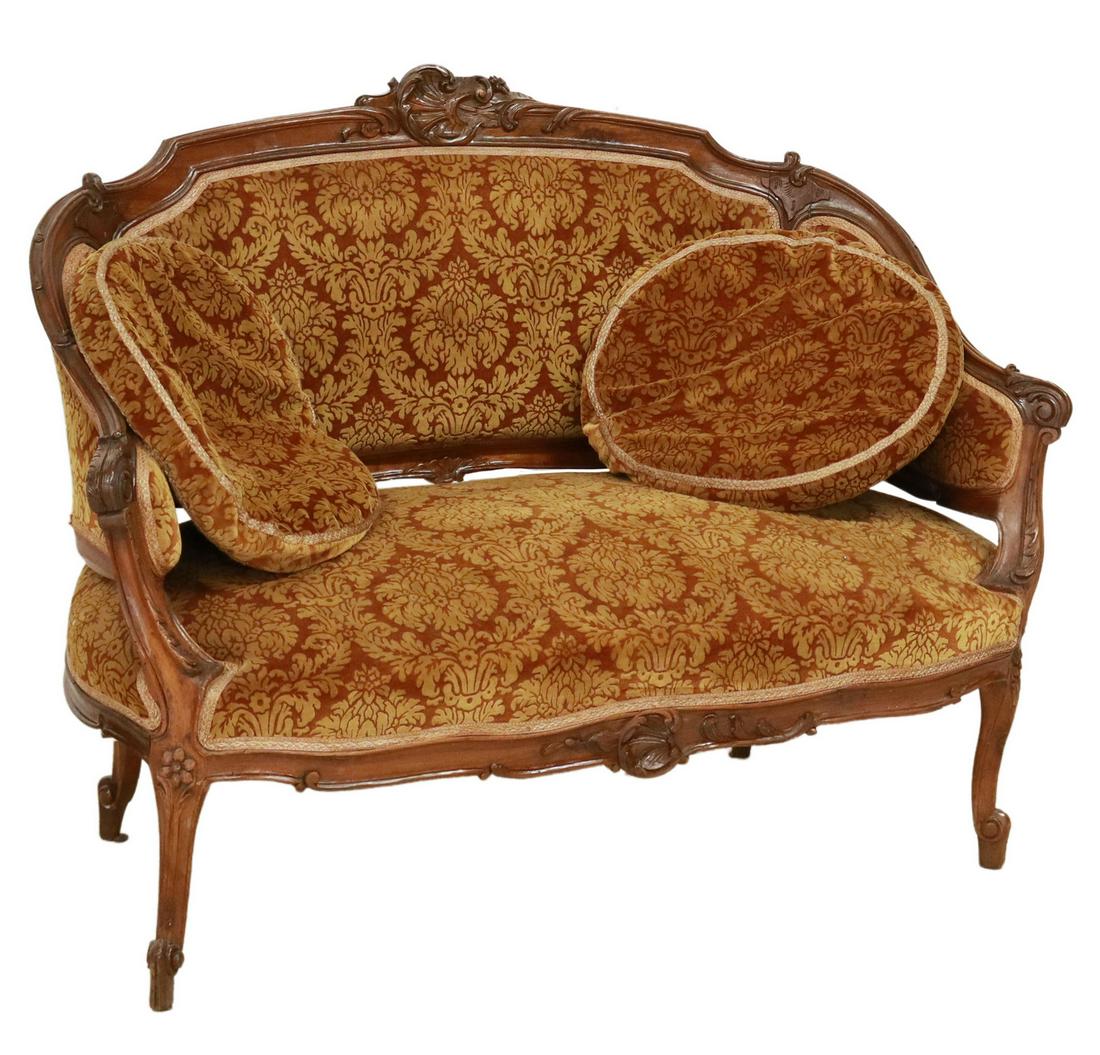 ITALIAN LOUIS XV STYLE UPHOLSTERED SETTEE SOFA: Italian Louis XV style settee/ sofa, 20th c., carved foliate crest, back and seat in damask upholstery, with carved acanthus arms, rising on cabriole legs, ending in whorl feet, approx 33"h, 45.5"w, 2