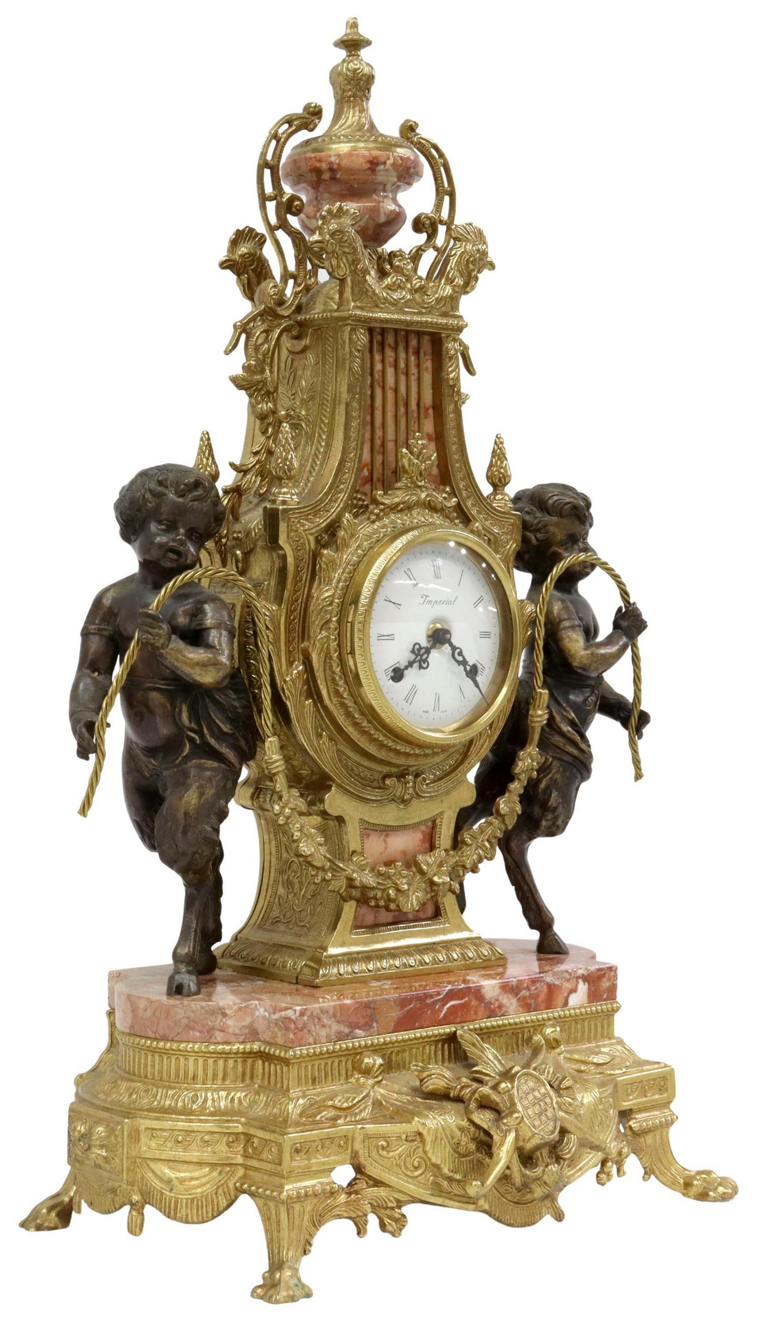 NEOCLASSICAL STYLE GILT METAL SATYR MANTEL CLOCK: Neoclassical style gilt metal mantel shelf clock, 20th c., urn-form finial over lyre harp case, cockerel masks, full-body putti satyr figures, flanking white enamel dial with Roman numeral hour marker