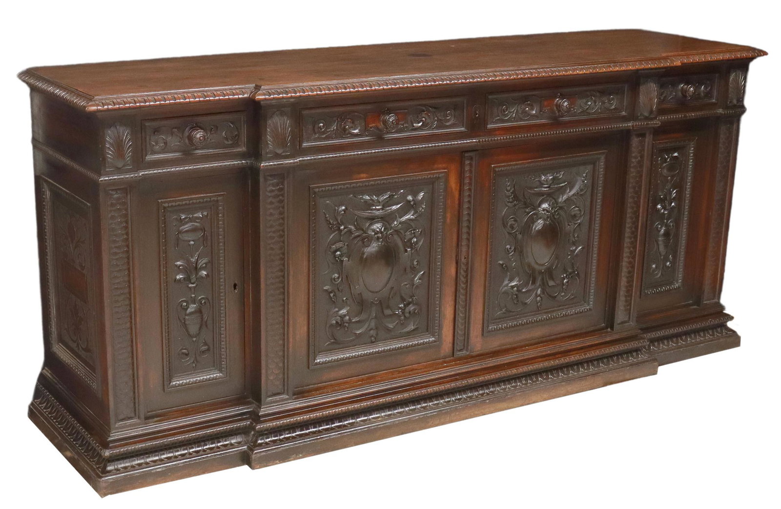 ITALIAN RENAISSANCE REVIVAL WALNUT SIDEBOARD: Italian Renaissance Revival carved walnut sideboard, late 19th c., breakfront case fitted with four drawers, over four cabinet doors, rising on molded plinth base, approx 42.25"h, 95.5"w, 26"d Start P