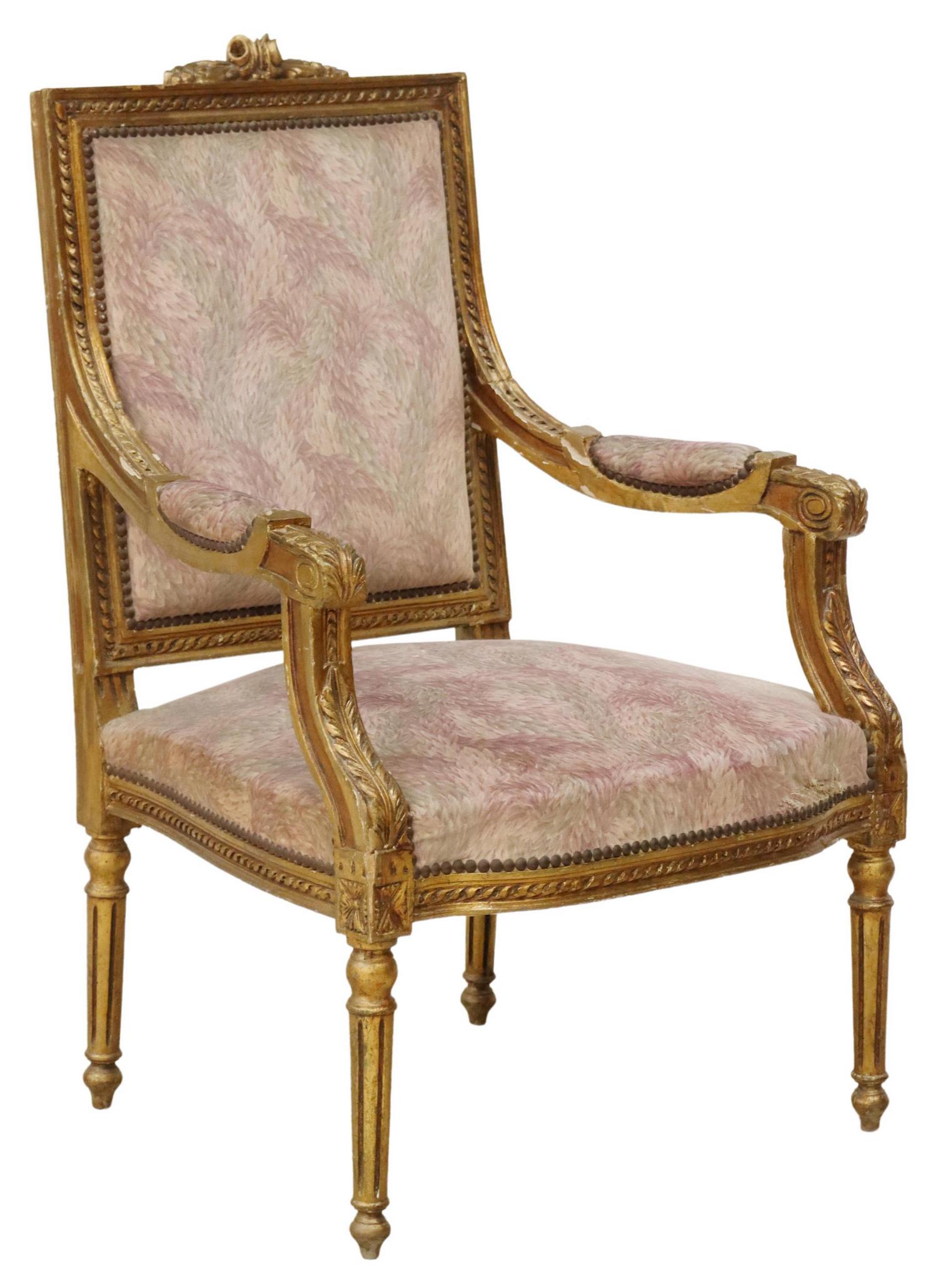 FRENCH LOUIS XVI STYLE GILTWOOD FAUTEUIL: French Louis XVI style armchair, early 20th c., giltwood frame, carved floral crest, running ribbon trim, back and seat in foliate upholstery, with nailhead trim, acanthus scrolled handholds, rising o
