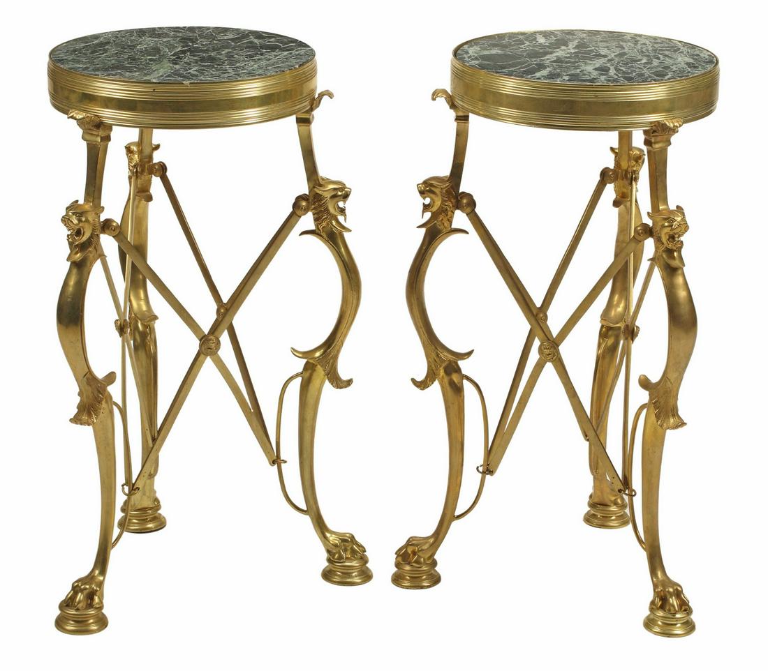 (2) NEOCLASSICAL STYLE BRONZE DORE GUERIDONS: (pair) Neoclassical style bronze dore side tables, after Louis-Constant Sevin (French, 1821-1888), inset marble top, scrolled supports with lions' heads, rising on paw feet, approx 26.5"h, 15"diam Sta