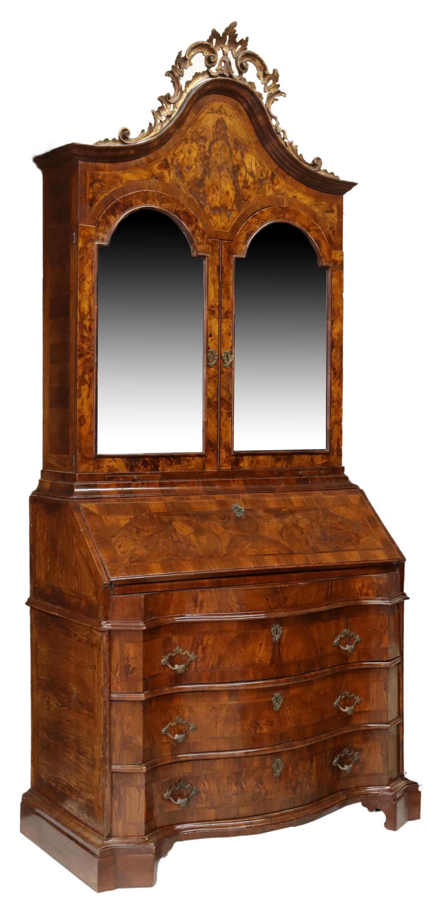 VENETIAN BURL WALNUT MIRRORED SECRETARY BOOKCASE: Venetian burl walnut secretary bookcase, early 20th c., foliate scroll crest, two doors faced with flat mirror plates, worn lined interior with two gilt metal sconces, over slant front opening to inte