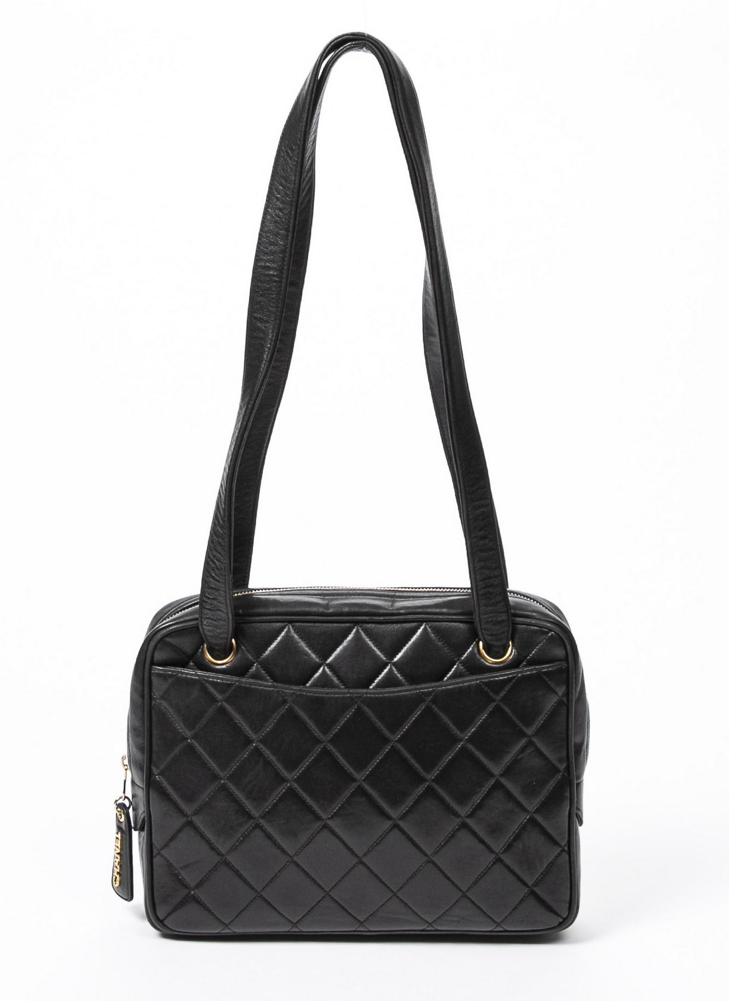 CHANEL BLACK QUILTED LEATHER SHOULDER BAG: Chanel shoulder bag, in black quilted leather, gold tone hardware, with dual flat shoulder straps, two exterior slip pockets, zip closure at top, opening to black interior, containing zip pocket and s