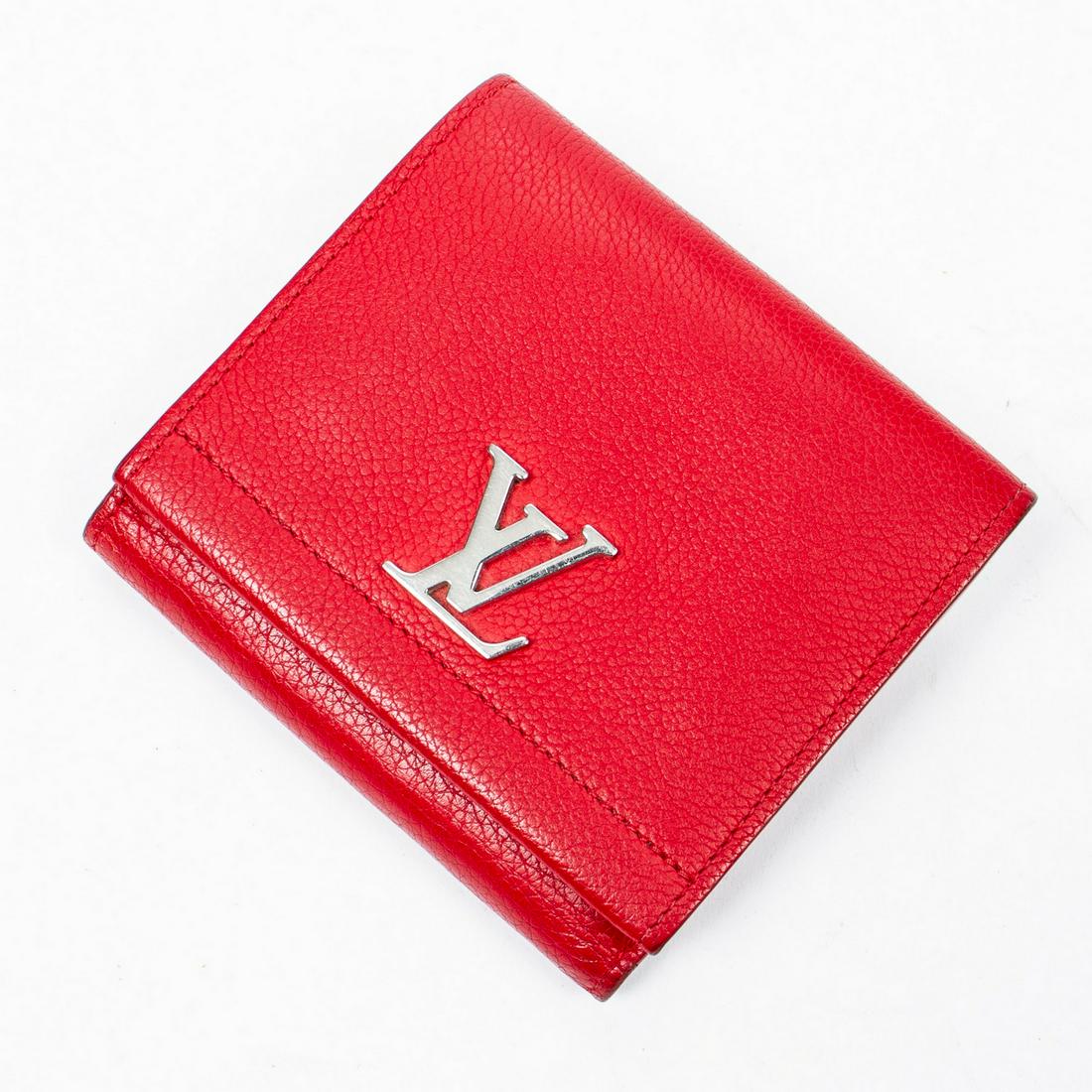 LOUIS VUITTON LOCK ME II RED LEATHER WALLET: Louis Vuitton "Lock Me II" compact wallet, in red leather, having silver hardware, snap closure at front and back, four slip pockets, eight card slots, single bill compartment, some wear, impressions