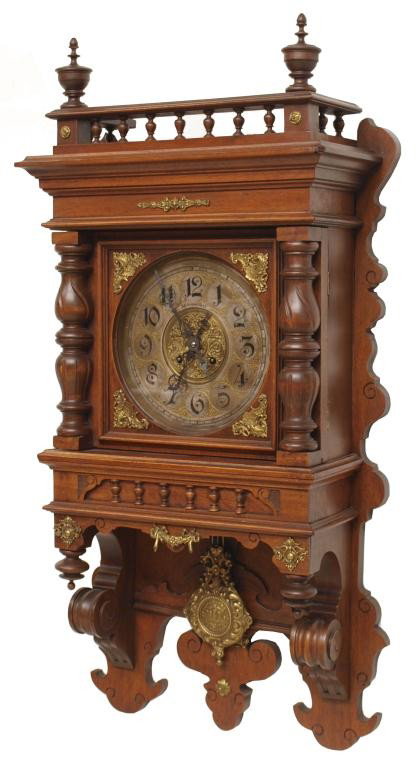 GUSTAV BECKER WALNUT CASED WALL CLOCK: German walnut cased wall clock, c.1900, gilt metal dial bearing the name of retailer Joh Greiner Craz, time and strike works with the mark of Gustav Becker, 36"h, 19'w, 8"d, 24lbs Start Price: $200.00