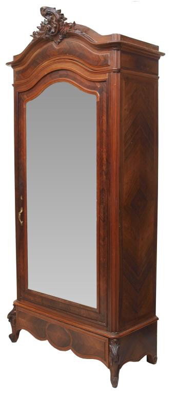 FINE FRENCH CARVED ROSEWOOD SINGLE DOOR ARMOIRE: French Louis XV style armoire, the arched top surmounted by a foliated rocaille crest, structure with matched rosewood veneers set with a single beveled mirror door, above a concealed drawer, the inte