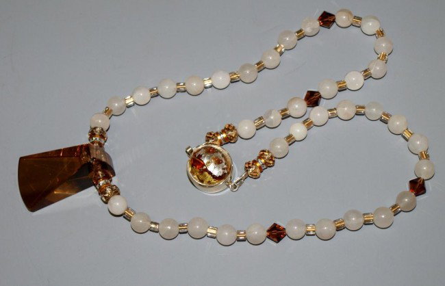 LADIES ARTISAN ART GLASS & SNOW QUARTZ NECKLACE: Artisan crafted necklace, white snow quartz beads separated by Swarovski and other crystal spacers, unusual light copper tone glass center, 925 clasp with art glass cabochon, 22.75"l Start Price: $100