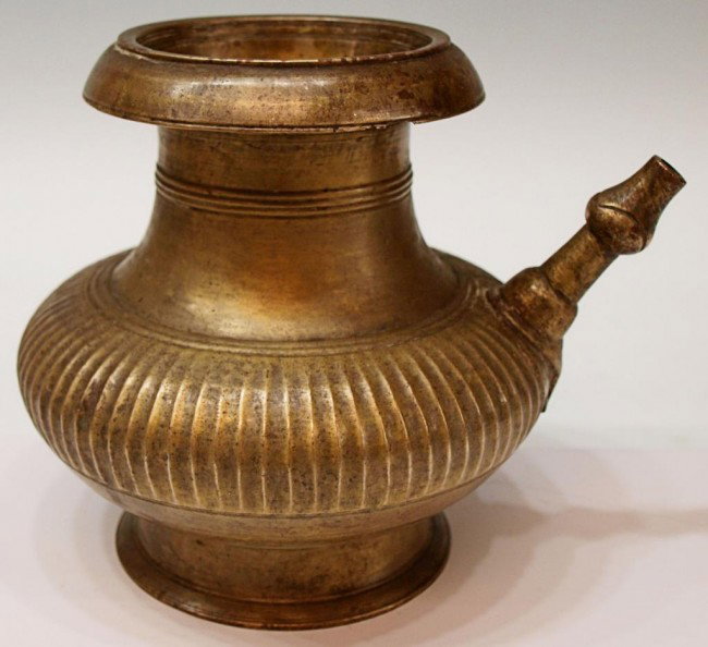 17TH C ISLAMIC BRASS VESSEL: Islamic brass vessel, North India, 17th c, ribbed body with a short spout, 7.75"h, 8"w, 5.25lbs **Reference: "Gold , Silver and Bronze from Mughal India", by Marc Zebrowski, page 142** Start Price: $2