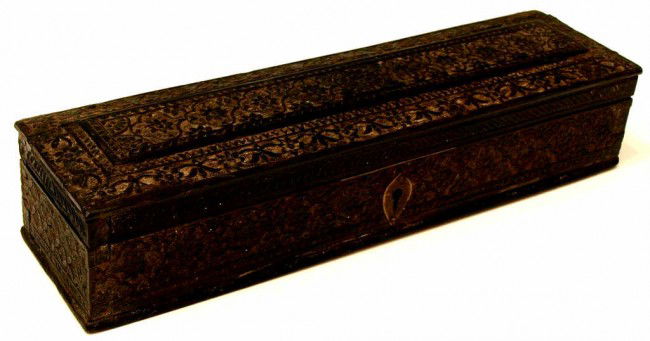 EARLY 19TH C. FINELY CARVED MUGHAL EBONY PEN BOX: Mughal ebony pen box, from the kingdom of Oudh (present day Lucknow, Indian), early 19th c., finely carved with typical Mughal floral and vining foliate patterns, sectioned interior, 2"h, 10.5"l, 2.75