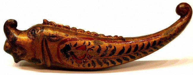 18TH C. MUGHAL LACQUER MYTHICAL BEAST POWDER FLASK: Mughal powder flask, 18th c., in the form of a Makar, retaining the original lacquer decoration, 8.25"l, 2"w, .5lb Start Price: $600.00