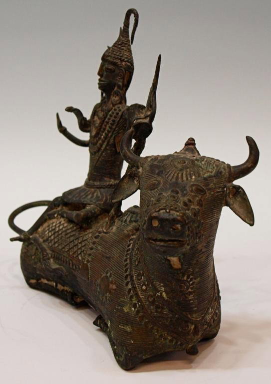 ANTIQUE INDIA BRONZE, YOGI SHIVA SEATED ON NANDI: Bronze statue, Yogi Shiva seated on his bull Nandi, Konde tribes, Orissa, NE India, late 17th/early 18th c., cast in the cire-perdu process the figure elaborately dressed with his right hand expressin