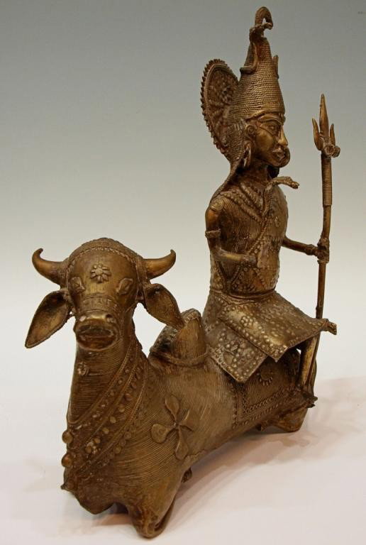 ANTIQUE INDIA BRONZE, YOGI SHIVA SEATED ON NANDI: Bronze statue, Yogi Shiva seated on his bull Nandi, Konde tribes, Orissa, NE India, late 17th/early 18th c., cast in the cire-perdu process the figure elaborately dressed with his right hand expressin