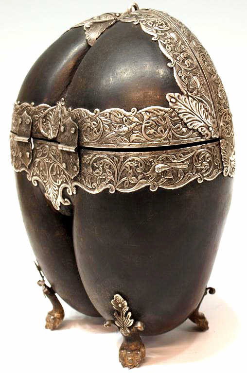 18TH C. INDO-PORTUGUESE COCO-DE-MER SILVER BOX: Indo-Portuguese silver mounted coco-de-mer box, 18th c., repousse silver mountings detailed with dense, leafy foliage and birds, on silver claw feet, 10.5"h, 8"w, 2.25lbs Start Price: $2000.00