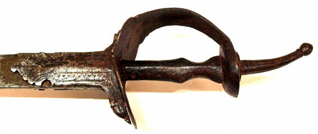 18C INDO-PERSIAN KHANDA SWORD, MUGHAL ARMORY SEAL: Scarce Indo-Persian sword, 18th c., the sword is in the form of a khanda with a long pommel and a knuckle guard, fuller groove on either side of the wide, watered steel blade bearing a Mughal armory s