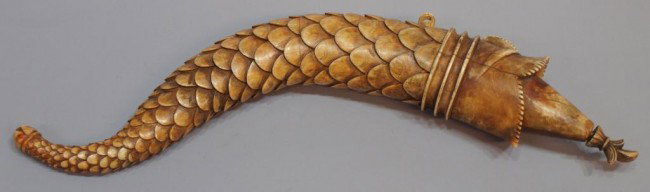 18TH C MUGHAL CARVED IVORY FISH SCALE POWDER FLASK: **This item will not be shipped Internationally*** A Mughal carved ivory powder flask, 18th c., the body of fish form finely detailed with scales and Makar face, the tail ending in the typical Mogra f