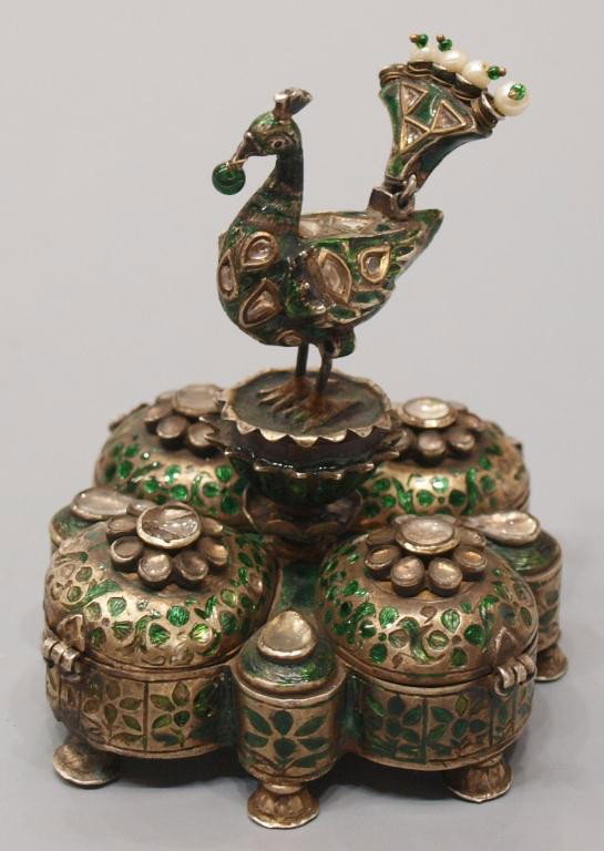 18TH C MUGHAL ENAMELED SILVER PEACOCK BOX: Rare Mughal enameled silver box, 18th c., a peacock finial centered by four compartments opening only after central finial is removed, enameling throughout set with rock crystal cabochons, peacock tai