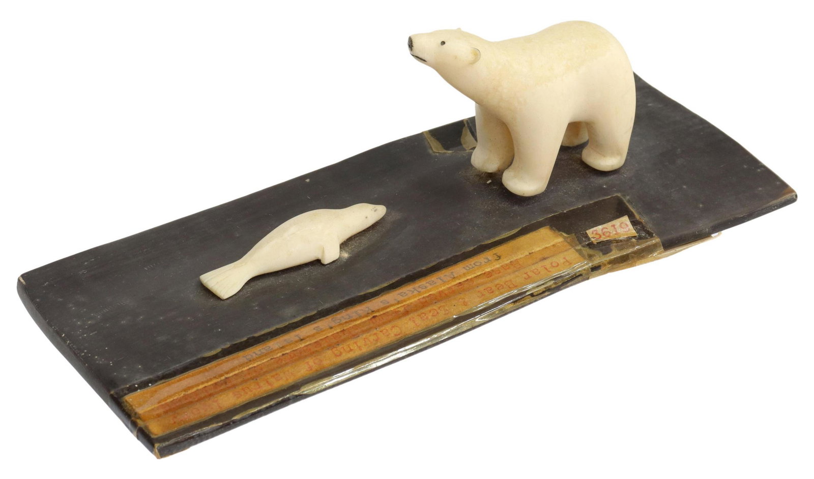 INUIT CARVED WALRUS TUSK POLAR BEAR & SEAL: Inuit carved walrus tusk, retaining tag identifying King's Island Alaska, modeled as a polar bear and seal, on whalebone/balleen base, retaining ANAC (Alaska Native Arts & Crafts Clearing House) card 