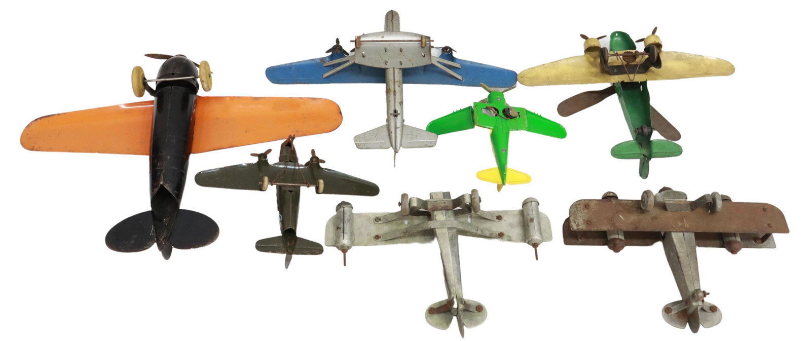 (7) VINTAGE PRESSED STEEL TOY AIRPLANES: (lot of 7) Vintage pressed steel toy airplanes, 20th c., featuring: (one) American folding-wing plane, Hubley Manufacturing Company, c.1960s, with plastic cabin canopy, marked "Lancaster, U.S.A" under
