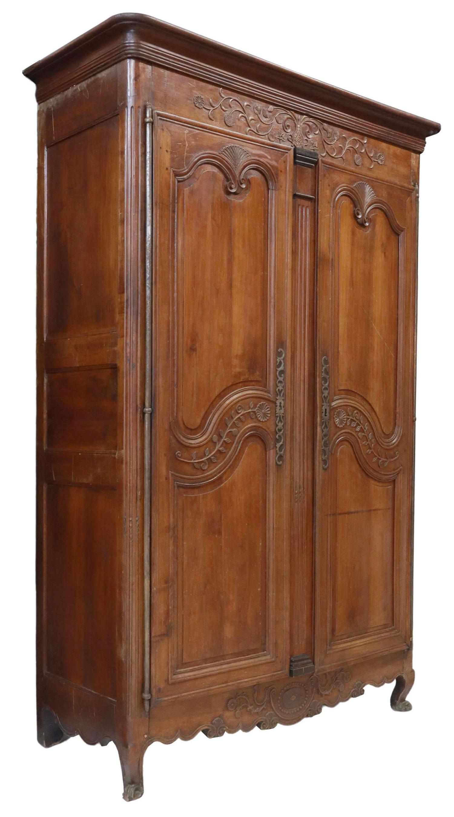 MONUMENTAL FRENCH PROVINCIAL ARMOIRE, 19TH C.: French Provincial Louis XV style armoire, early 19th c., molded cornice, over carved foliated ewer crest, paneled doors on long exterior hinges, above carved apron, rising on cabriole legs, ending in 