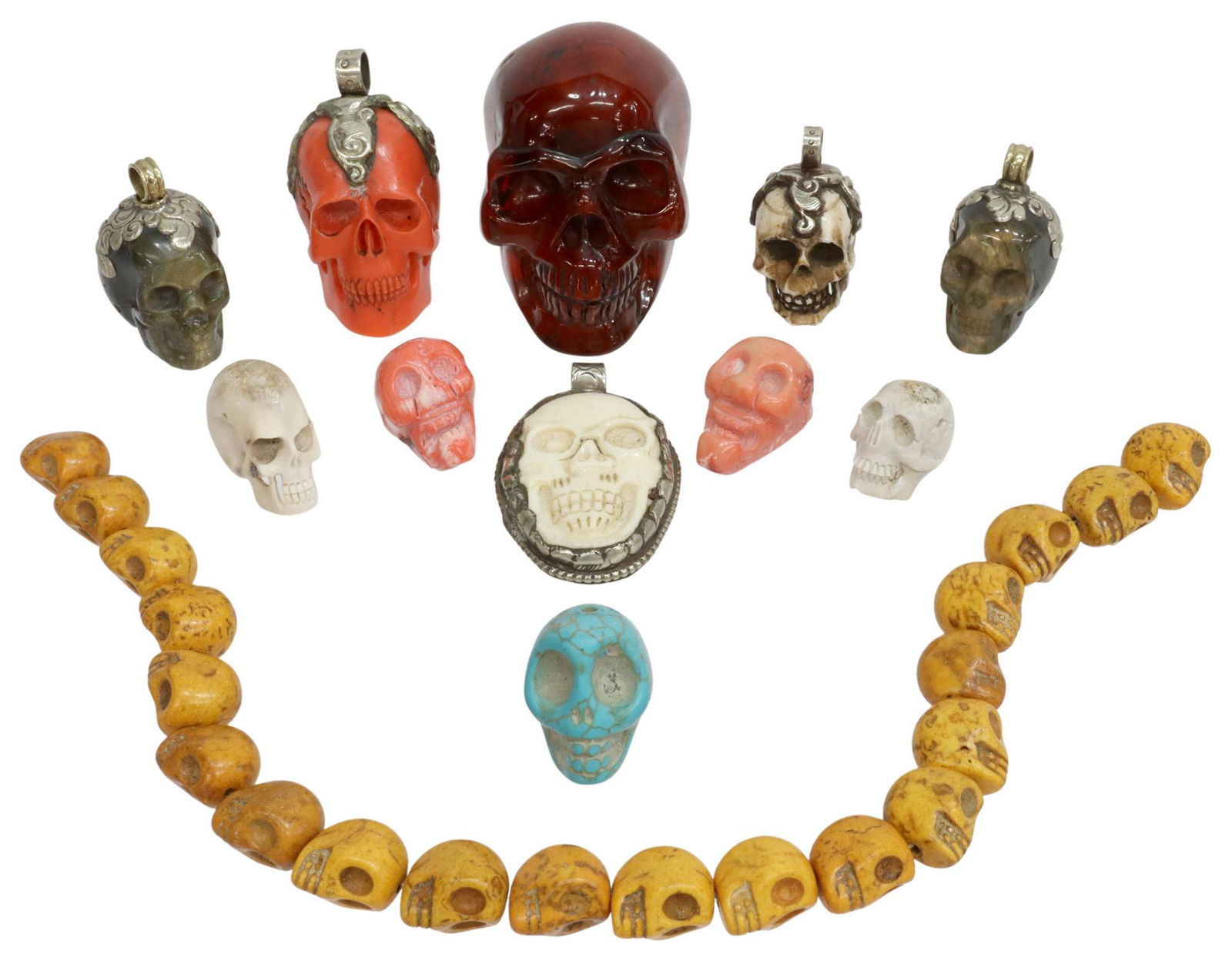 (12) COLLECTION OF SKULL BEADS, PENDANTS & DECOR: (lot of 12) Collection of skull beads, pendants, and table items, including: (5) carved hardstone skulls, (two) labradorite pendants, set in scrolled silver-tone metal mounts, (two) coral beads, (one)