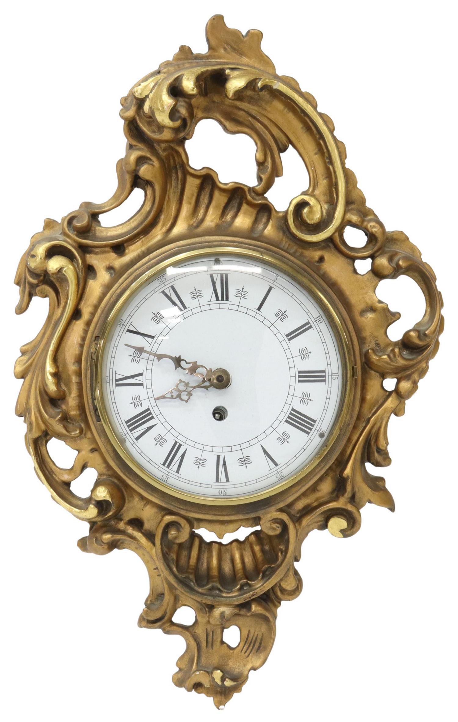 LOUIS XV STYLE GILTWOOD CARTEL CLOCK: Louis XV style giltwood cartel clock, 20th c., having hinged glass panel, over circular enamel dial with Roman numerals, later time-only movement, encased in scrolling foliate frame, approx 19"h, 12"w