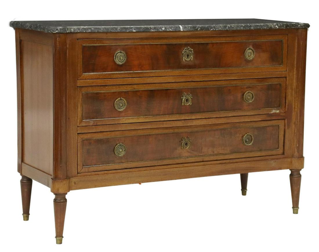 FRENCH LOUIS XVI STYLE MARBLE-TOP MAHOGANY COMMODE: French Louis XVI style mahogany commode, late 19th c., shaped marble top, conforming case fitted with three drawers, fluted corner posts, rising on tapered legs, approx 32.5"h, 46.25"w, 18.5"d Start P