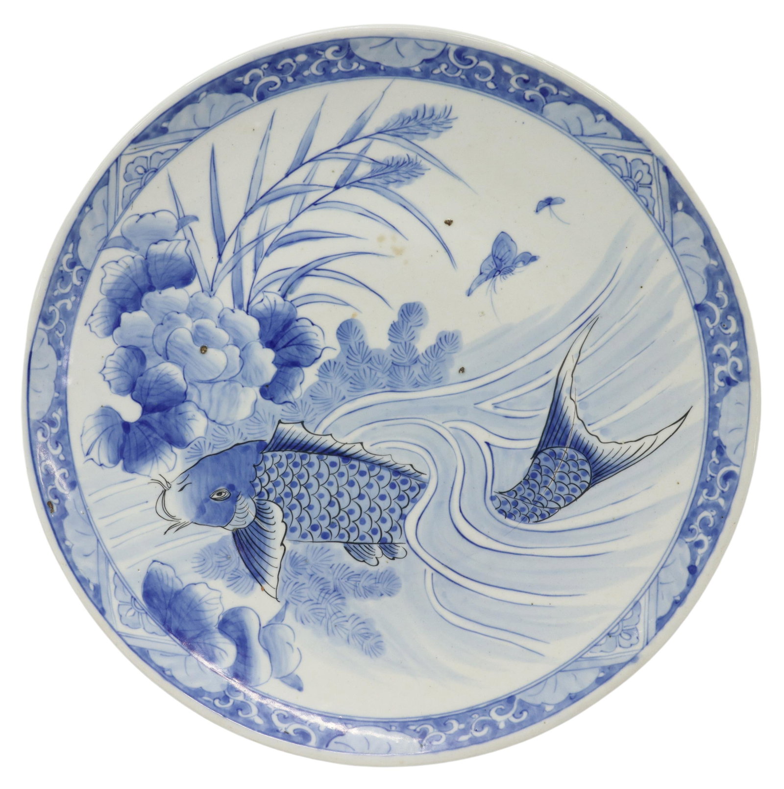 LARGE JAPANESE KOI FISH PORCELAIN 19" CHARGER: Large Japanese porcelain charger, depicting koi fish swimming amongst blossoms and foliage, scroll motifs at trim, some typical pitting and firing flaws, approx 18.75"diam, 3.75lbs **Provenance: From 