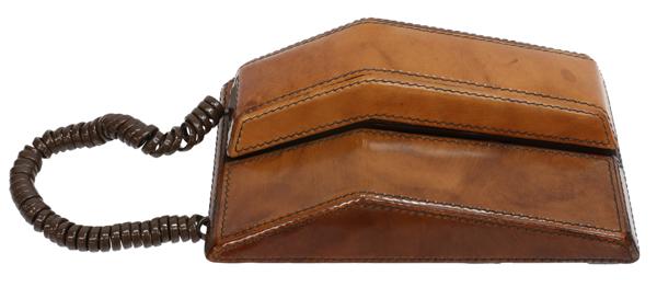 VINTAGE CONTEMPRA TALIA LEATHER-WRAPPED TELEPHONE: Vintage Contempra "Talia" tone dial telephone, c.1970s, wrapped in stitched brown leather, manufactured by Northern Telecom Limited, approx 3.5"h, 6"w, 5.5"d, 2lbs Start Price: $50.00