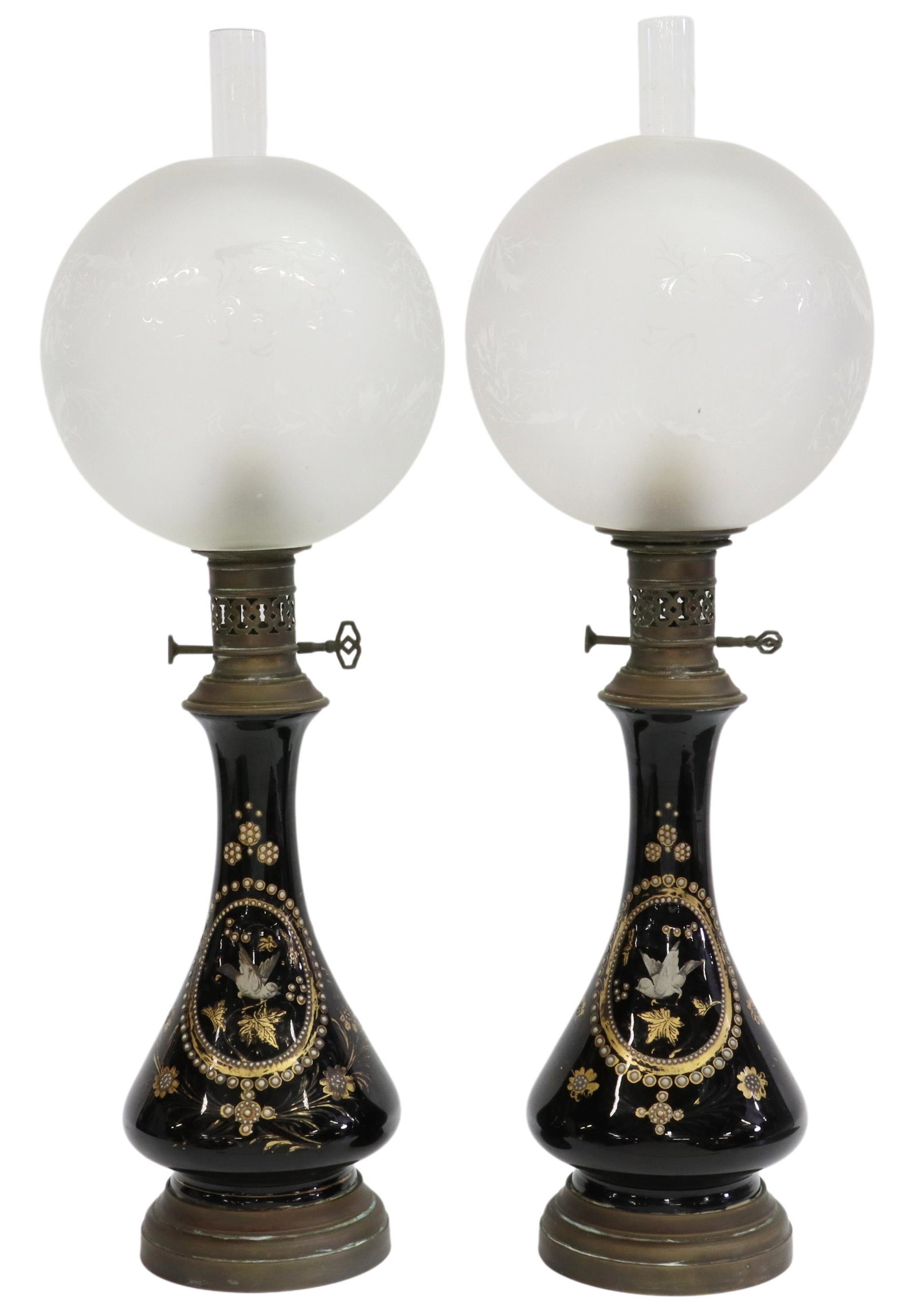 (2) FRENCH NAPOLEON III PERIOD PORCELAIN OIL LAMPS: (pair) French Napoleon III period porcelain oil lamps, 19th c., now electrified, each having colorless glass chimney, above frosted glass shade, painted porcelain body with central bird motif, parcel 