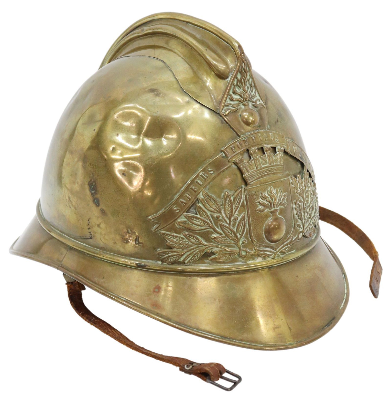 FRENCH BRASS FIREMAN'S HELMET, c.1890: French brass fireman's helmet, c.1890, the front emblem with banner reading "Sapeurs Pompiers V-M. & Co.," leather chin strap, dents, approx 7.75"h, 10.75"w, 7.75"d, 1.25lbs Start Price: $80.00