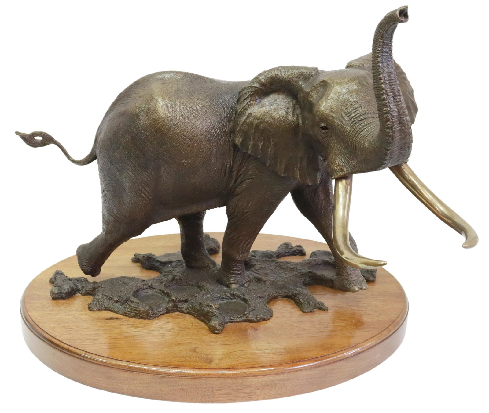 TOM TISCHLER (B.1950) BRONZE ELEPHANT SCULPTURE: Patinated bronze sculpture, "Alarmed by the Wind," signed in cast Tom Tischler (Texas, b.1950), numbered 2/25, dated 1981, on rotating wood plinth, approx 19"h, 22"w, 20"w, 72lbs Start Price: $600.00