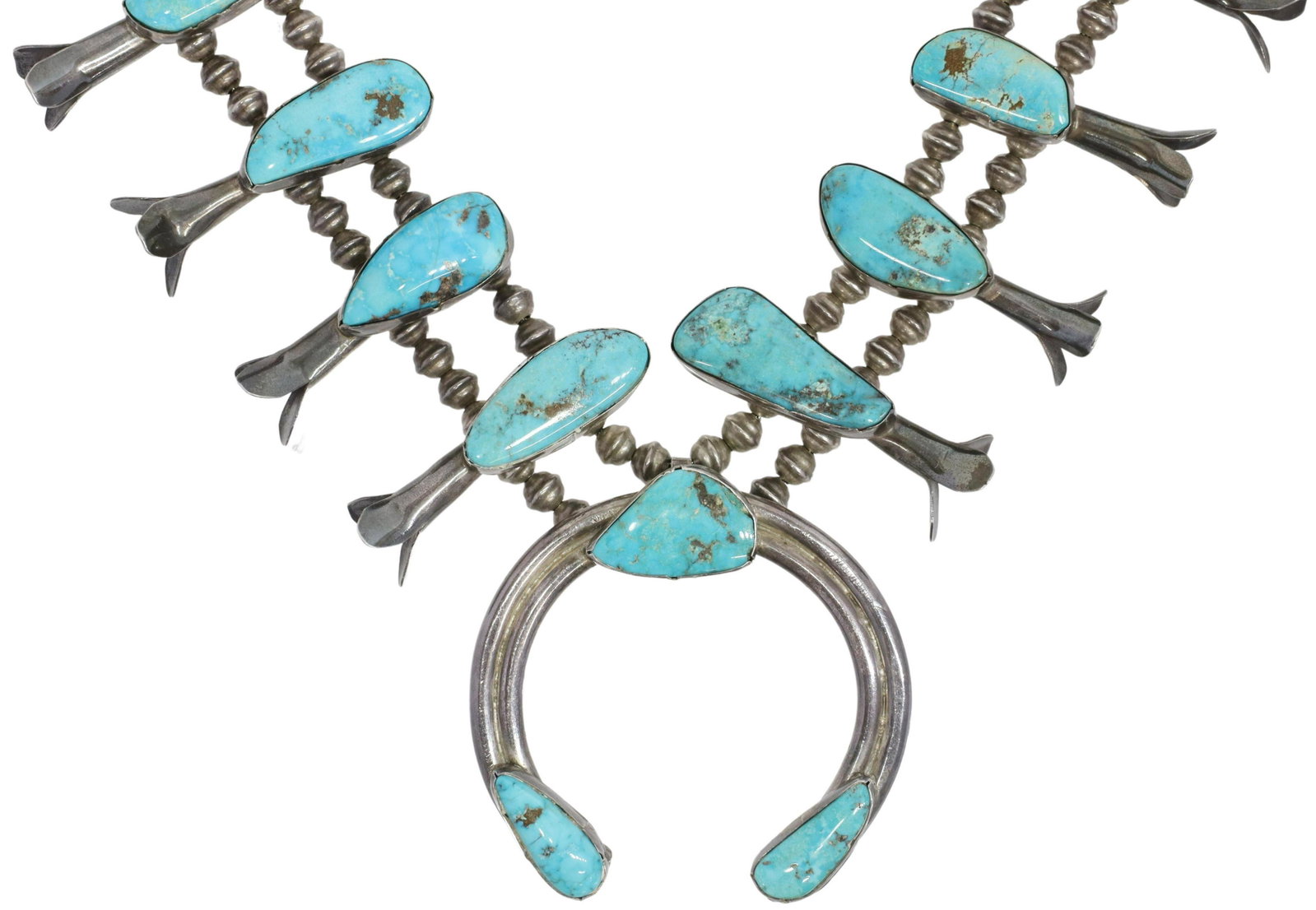 NATIVE AMERICAN TURQUOISE SQUASH BLOSSOM NECKLACE: Native American silver (content unknown) squash blossom necklace, twelve blossoms, each set with a turquoise cabochon, central naja pendant, double bench bead strands, ending in a single strand, hook 