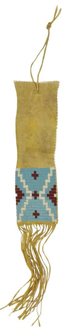 SIOUX BEADED HIDE TOBACCO BAG, C.1910-1925: Native American beaded hide tobacco bag, Sioux, c.1910-1925, long fringe, tag: Sioux, Carl Moon collection, approx 21"l, 6.25"w (exclusive of fringe), 0.5lbs Start Price: $150.00