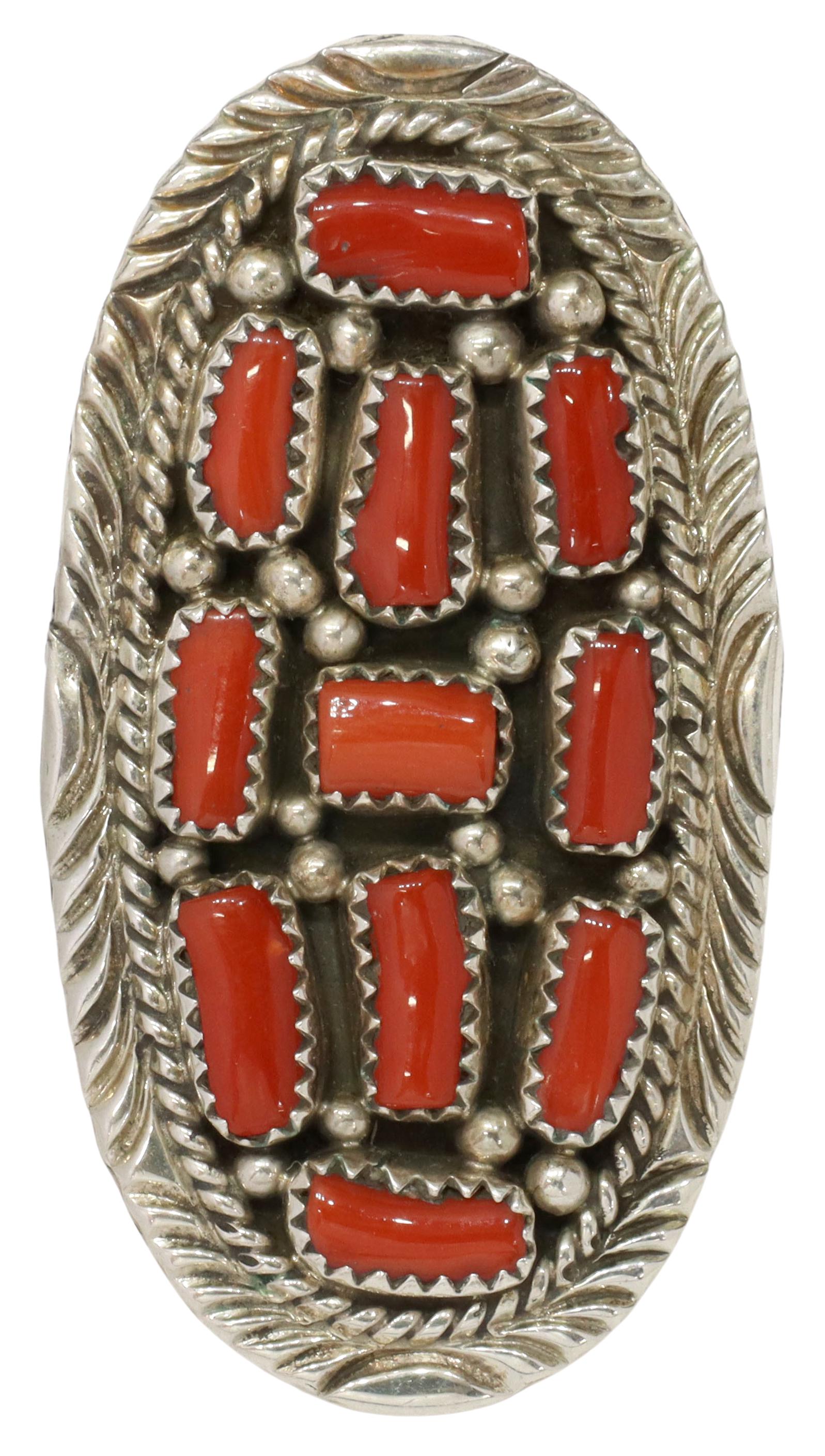 GENT'S MERLE HOUSE NAVAJO RED CORAL STERLING RING: Gent's Native American sterling silver ring, M.H. (Merle House, Navajo/ Dine, 20th c.), oval plaque set with eleven red coral segments in serrated bezels, on a split shank, plaque: approx 2 1/8"l, 1.2