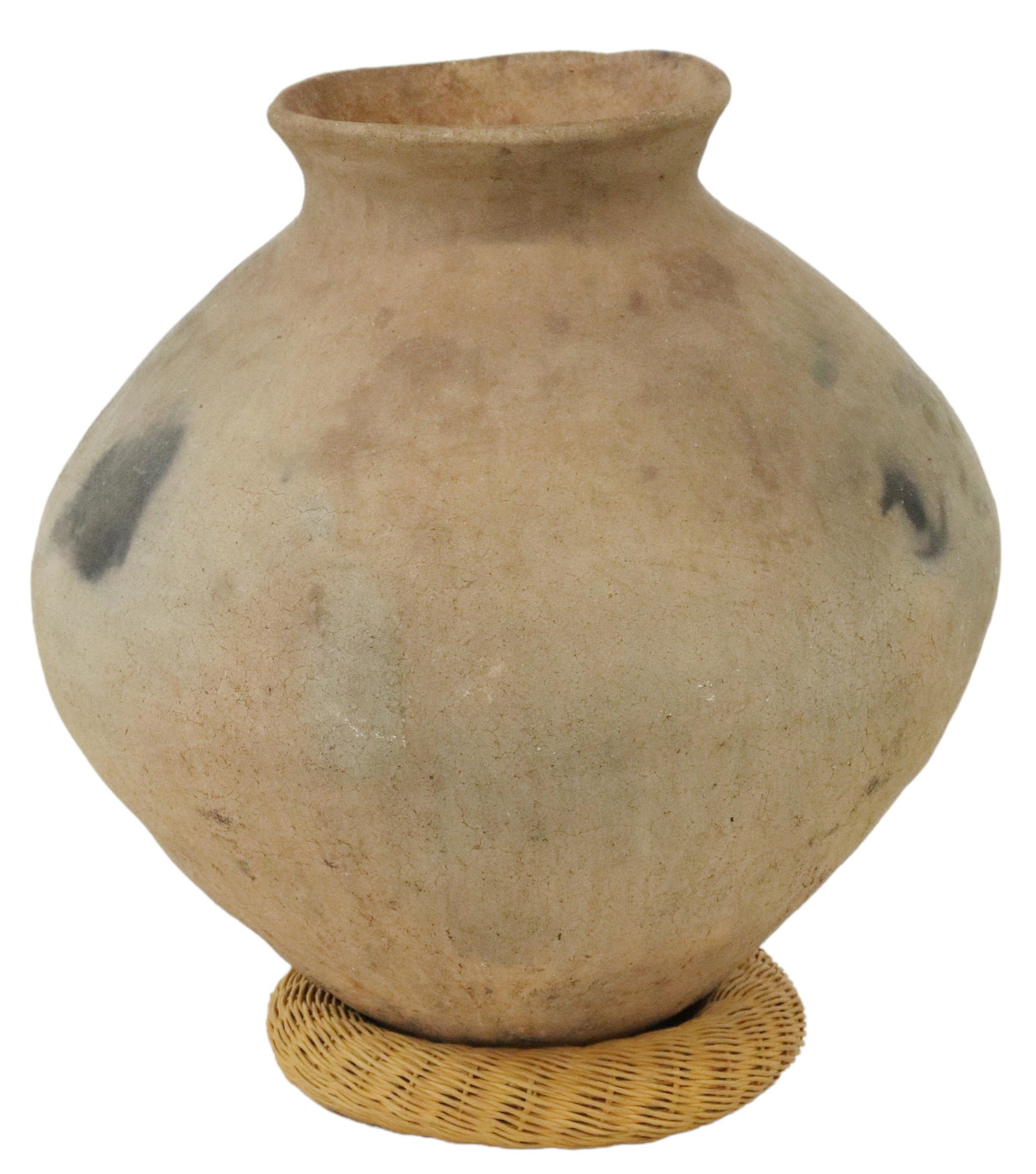 NORTHERN MEXICO POTTERY WATER JAR: Northern Mexico earthenware water jar, 20th c., having wide rim, over tapered body, with some black marks from kiln, rising on rattan woven stand, approx 17"h, 16"diam, 14.5lbs **Provenance: From the 