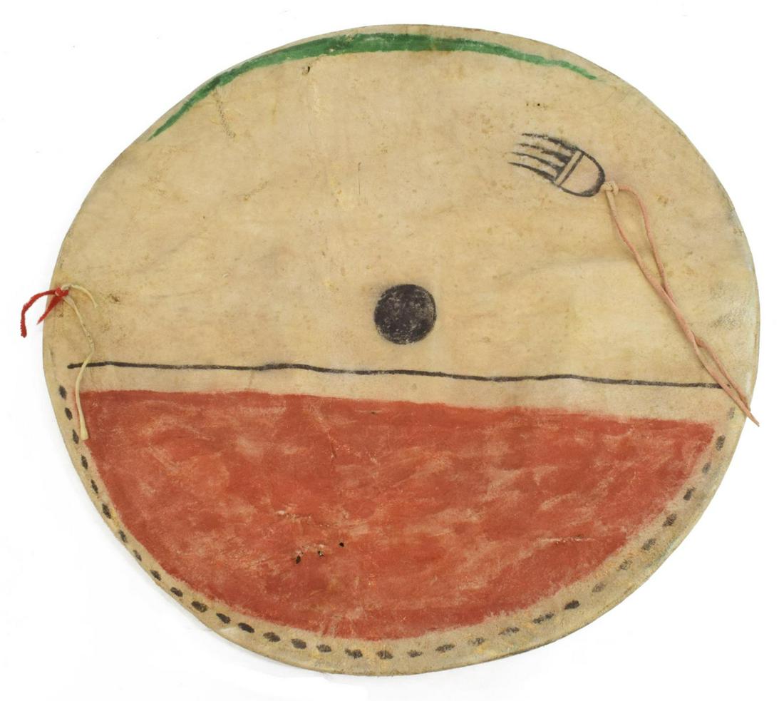 REPLICA PLAINS-STYLE PAINTED HIDE SHIELD COVER: Replica Plains-style painted hide shield cover, enclosing a rawhide shield, contemporary, front with red, green, and black pigment, bear claw depicted in top right quadrant, approx 17.5"diam Start Pri