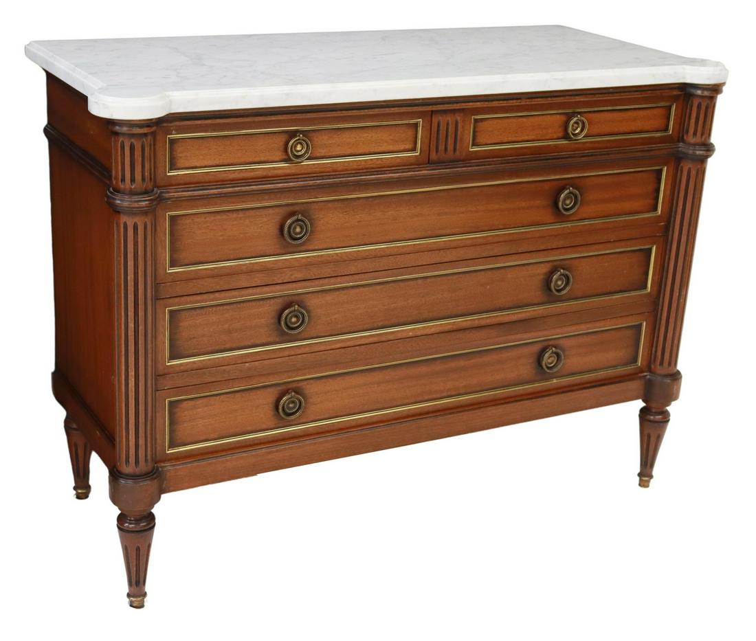 FRENCH LOUIS XVI STYLE MARBLE-TOP MAHOGANY COMMODE: French Louis XVI style mahogany commode, 20th c., shaped marble top, over five paneled drawers with gilt metal trim, flanked by fluted corner posts, rising on tapered legs, ending in brass cap feet, a
