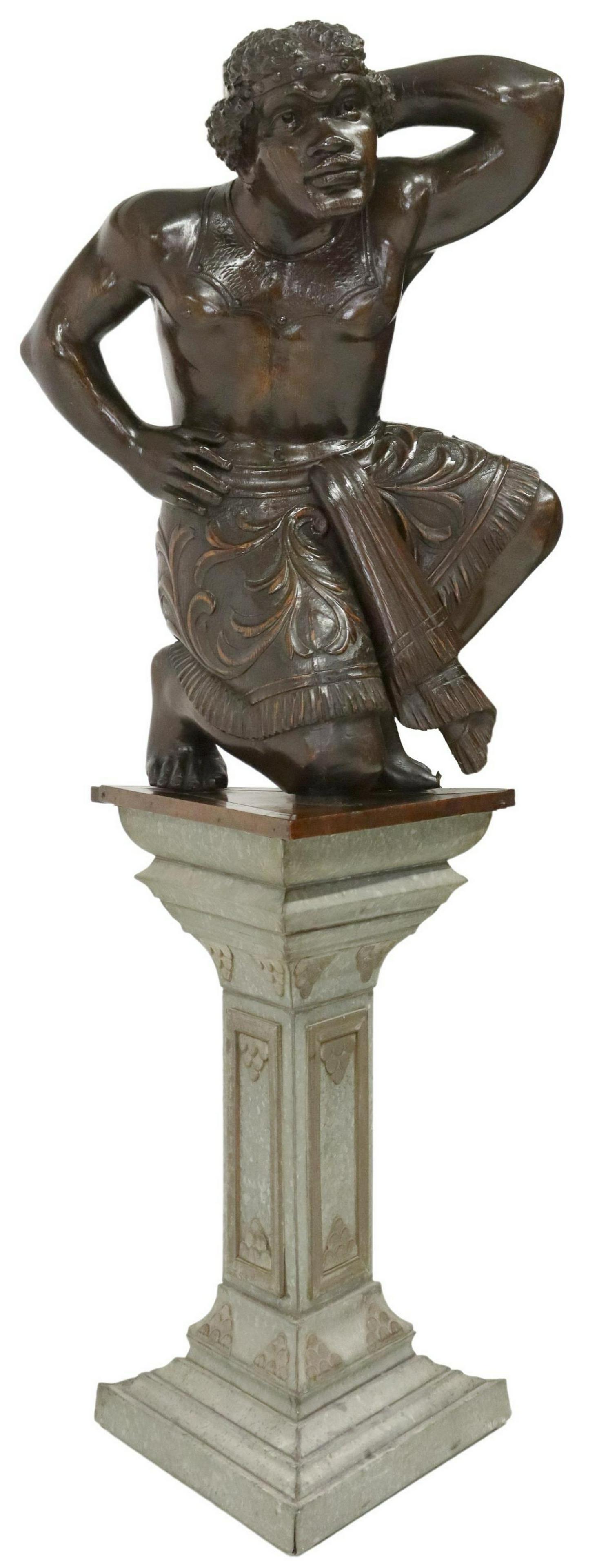 NEAR LIFE-SIZE ITALIAN CARVED BLACKAMOOR, 67"H: Near life-size Italian carved wood Blackamoor sculpture, 19th c., rising on paneled triangular tin pedestal, on stepped base, figure: approx 35"h, 25"w, 21"d, overall: approx 67"h, 27"w, 21"d **Proven