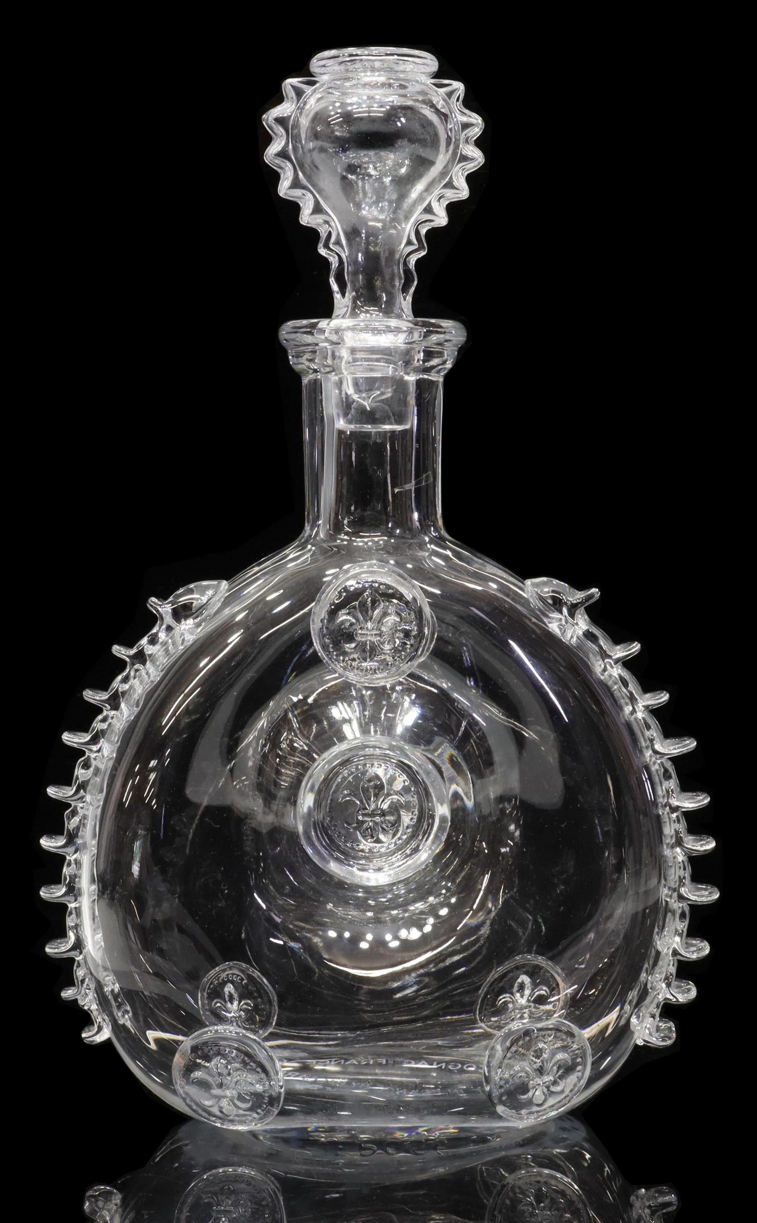 BACCARAT CRYSTAL REMY MARTIN LOUIS XIII DECANTER: Baccarat crystal Louis XIII cognac decanter, for Remy Martin, with embossed fleur-de-lis and ruffled sides, teardrop-form stopper with conforming ruffles, acid-etched mark underfoot, base and stopper 