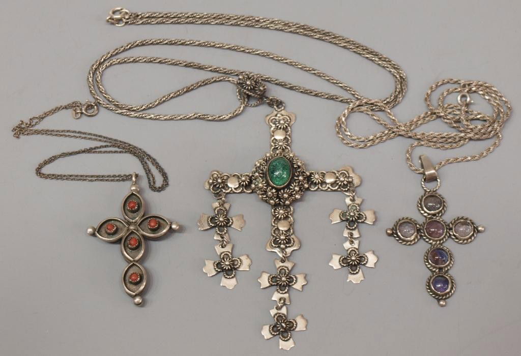 JEWELRY VINTAGE MEXICO TAXCO 925 STERLING CROSSES: (lot of 3) Sterling silver cross pendants, each hung on a silver chain, including: (1) very fine example detailed with flowers, dandles and central green stone, eagle mark for Taxco, other marks as pi