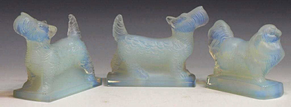 FRENCH SABINO OPALESCENT ART GLASS DOG FIGURES: (lot of 3) Sabino opalescent art glass figures, (2) Scottie dogs and (1) Pekinese, marks include 'Sabino Paris' and 'Sabino France', one retaining paper label, largest: 3"h, 3.75"l, Start Price: $150.