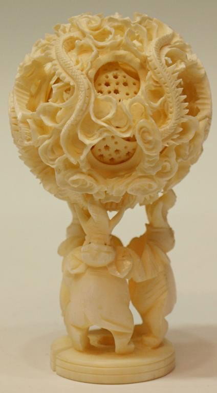 LARGE CHINESE CARVED IVORY DRAGON PUZZLE BALL: ***International shipping is not available for this item*** Chinese carved ivory puzzle ball the exterior intricately carved with a writhing dragon amidst flowers and birds, interior layers in a pierc